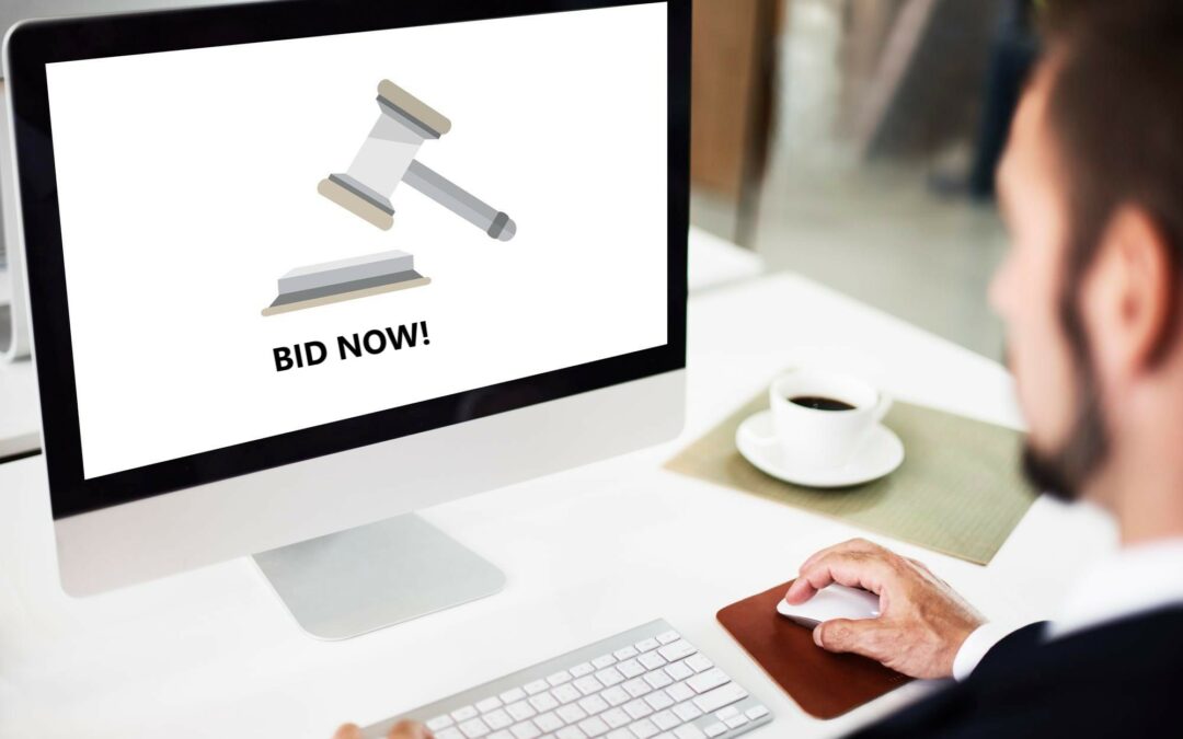 man making bid on machinery at online equipment auction